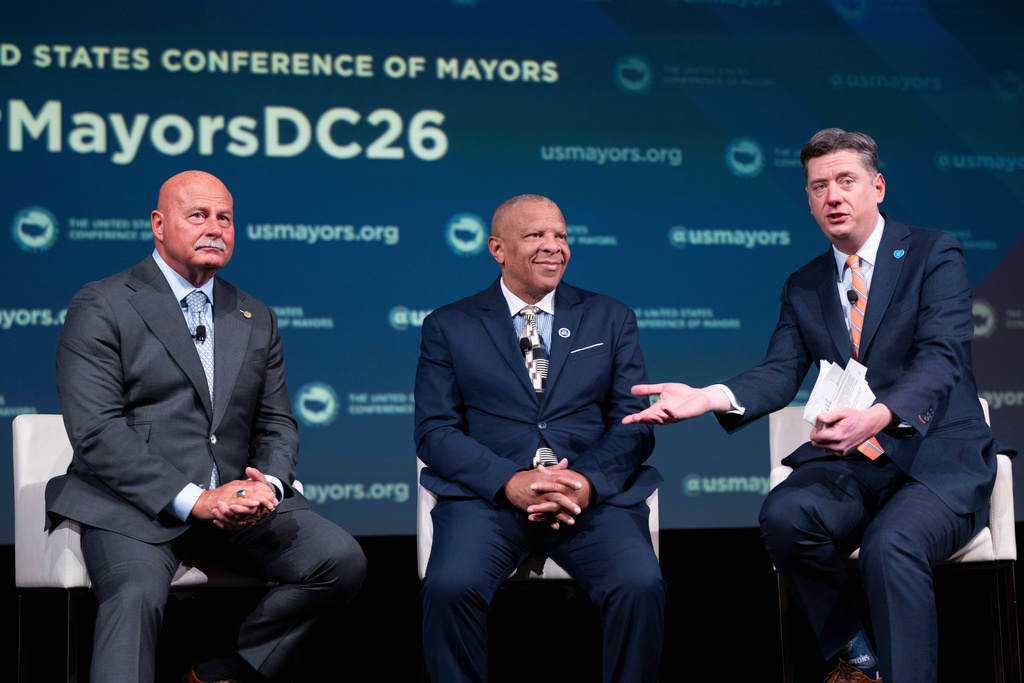 Oklahoma City Mayor David Holt, right, speaks during a panel discussion with Fresno, Calif. Mayor Jerry Dyer, left, and Omaha, Neb. Mayor John Ewing, Jr. during the 94th Winter Meeting of the U.S. Conference of Mayors, Wednesday, Jan. 28, 2026 in Washington. (AP Photo/Kevin Wolf)