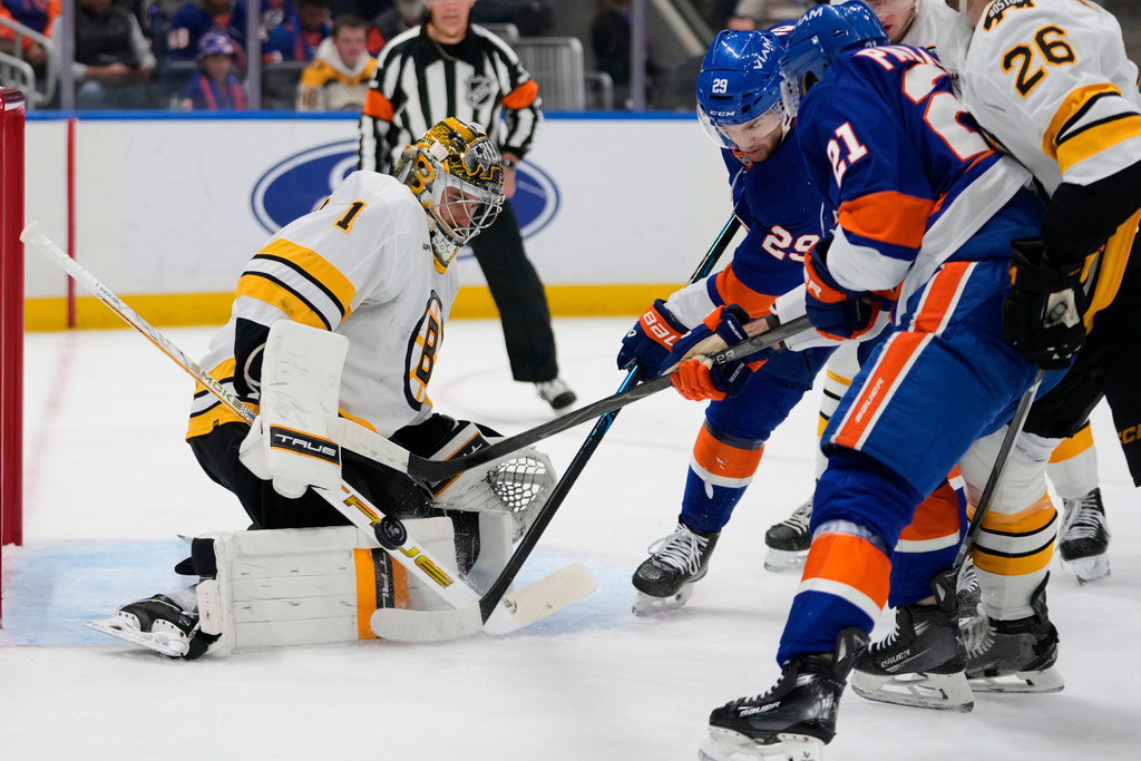 Boston Bruins goaltender Jeremy Swayman (1) stops a shot byu New York Islanders' Jonathan Drouin (29) during the second period of an NHL hockey game Tuesday, Nov. 4, 2025, at UBS Arena in Elmont, N.Y. (AP Photo/Frank Franklin II)