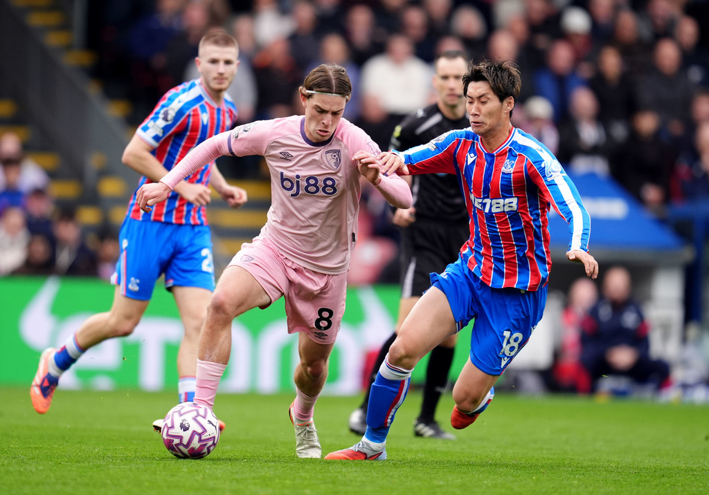 Bournemouth's Alex Scott and Crystal Palace's Daichi Kamada, right, in action during the English Premier League soccer match between Crystal Palace and Bournemouth in London, Saturday Oct. 18, 2025. (Adam Davy/PA via AP)