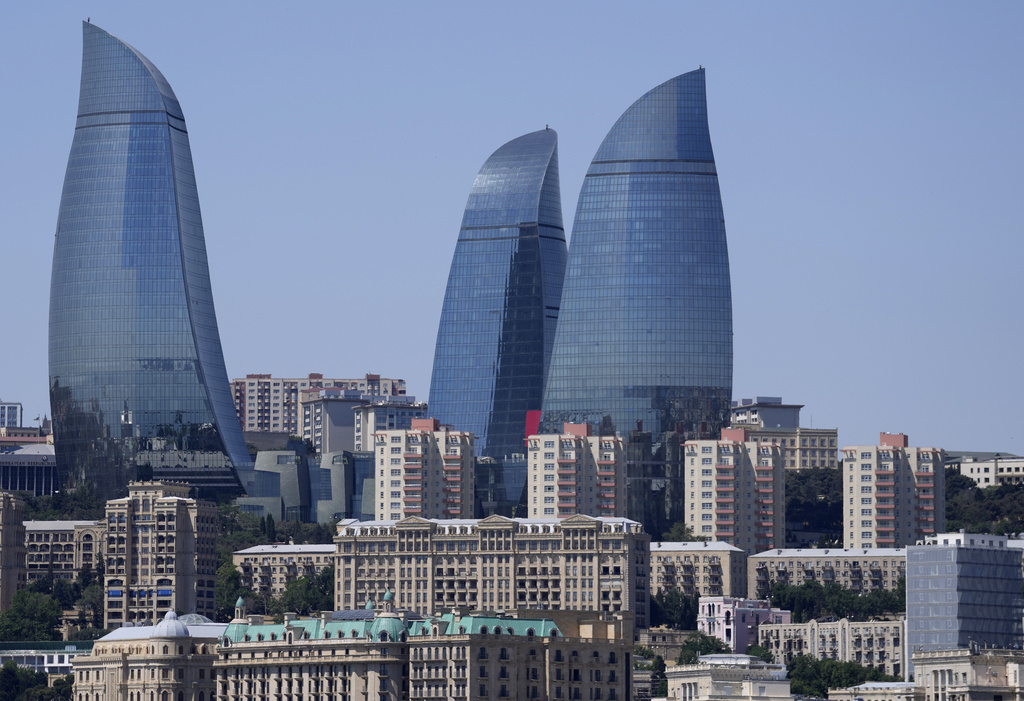 FILE - The Old City stands with the Flame Towers skyscrapers in background in Baku, Azerbaijan, June 13, 2021. (AP Photo/Darko Vojinovic, File)