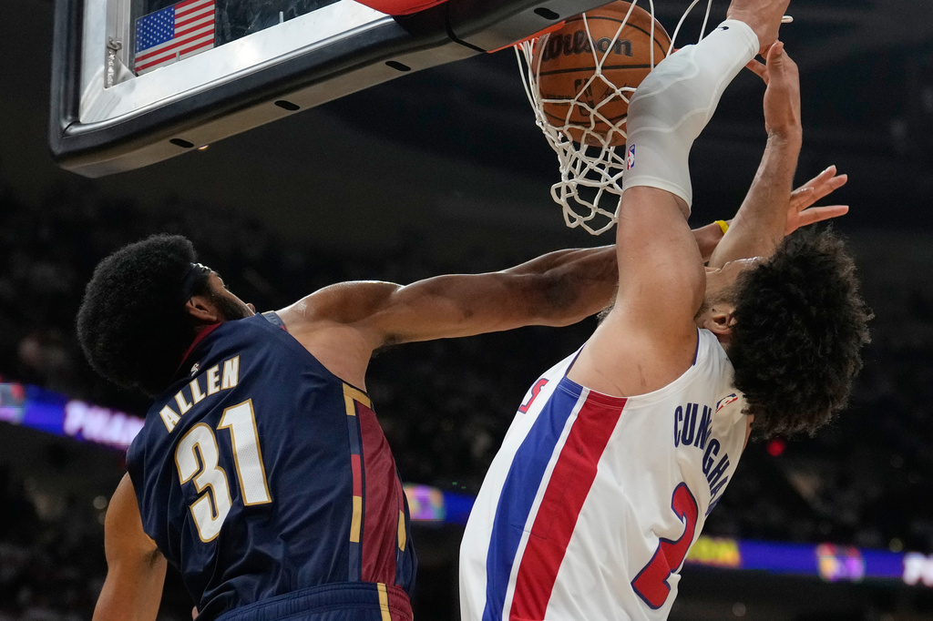 Detroit Pistons guard Cade Cunningham (2) dunks as Cleveland Cavaliers center Jarrett Allen (31) defends in the second half of Game 3 of a second-round NBA playoffs basketball series Saturday, May 9, 2026 in Cleveland. (AP Photo/Sue Ogrocki)