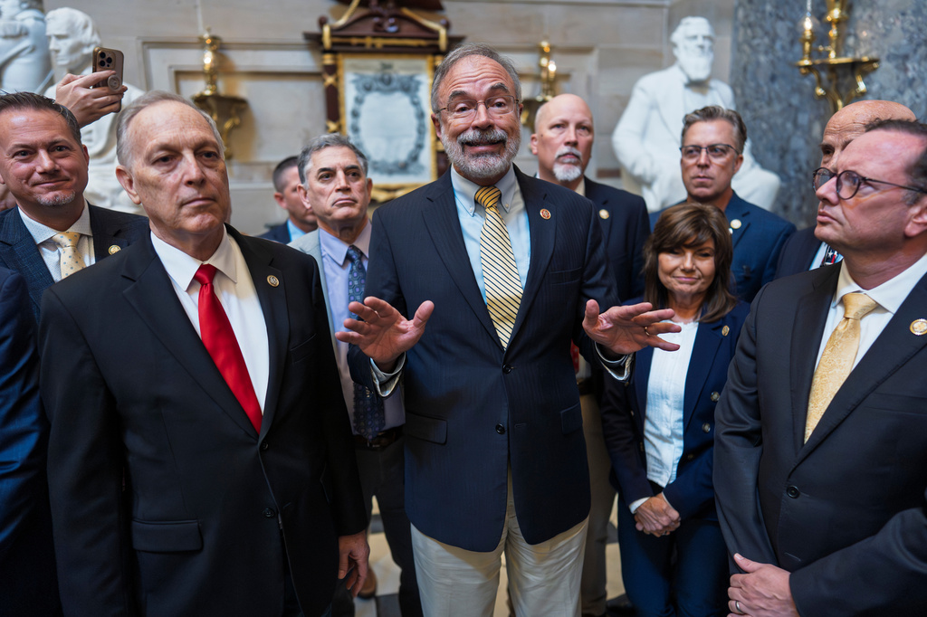 After a deal was approved in the Senate to fund the Department of Homeland Security, except for immigration operations, members of the conservative House Freedom Caucus, including Rep. Andy Biggs, R-Ariz., left, and Rep. Andy Harris, R-Md., center, tell reporters that they won't vote in the House to pass it as is, at the Capitol in Washington, Friday, March 27, 2026. (AP Photo/J. Scott Applewhite)