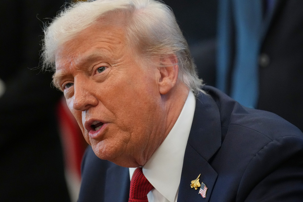 President Donald Trump speaks to reporters before signing an executive order in the Oval Office at the White House, Monday, Oct. 6, 2025, in Washington. (AP Photo/Jacquelyn Martin)