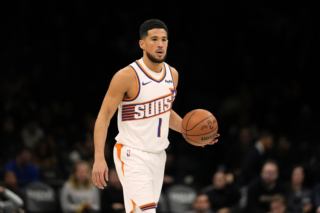 Phoenix Suns' Devin Booker (1) looks to pass during the first half of an NBA basketball game against the Brooklyn Nets Monday, Jan. 19, 2026, in New York. (AP Photo/Frank Franklin II)