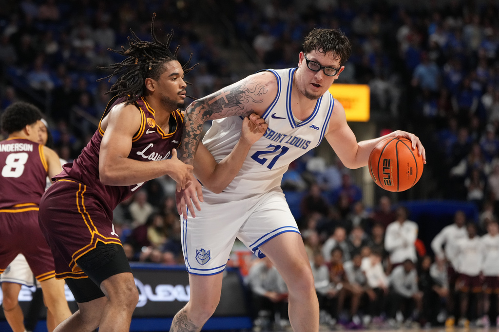 Saint Louis' Robbie Avila (21) dribbles as Loyola Chicago's Kayde Dotson defends during the second half of an NCAA college basketball game Wednesday, March 4, 2026, in St. Louis. (AP Photo/Jeff Roberson)