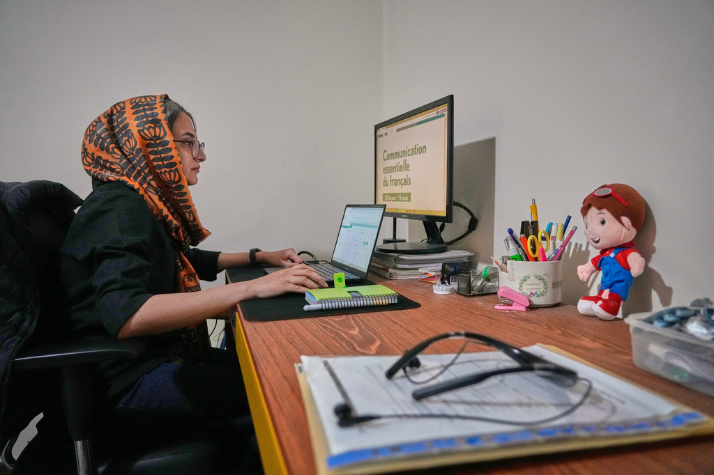Zahra Arghavan works on her computer at home in Tehran, Iran, Sunday, April 5, 2026. (AP Photo/Vahid Salemi)