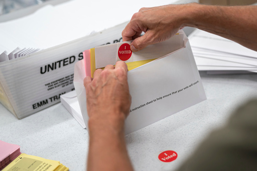 FILE - Todd Gallagher prepares mail in ballot envelopes including an I Voted sticker, July 29, 2020 in Minneapolis. (Glen Stubbe/Star Tribune via AP, File) FILE - Todd Gallagher prepares mail in ballot envelopes including an I Voted sticker, July 29, 2020 in Minneapolis. (Glen Stubbe/Star Tribune via AP, File)