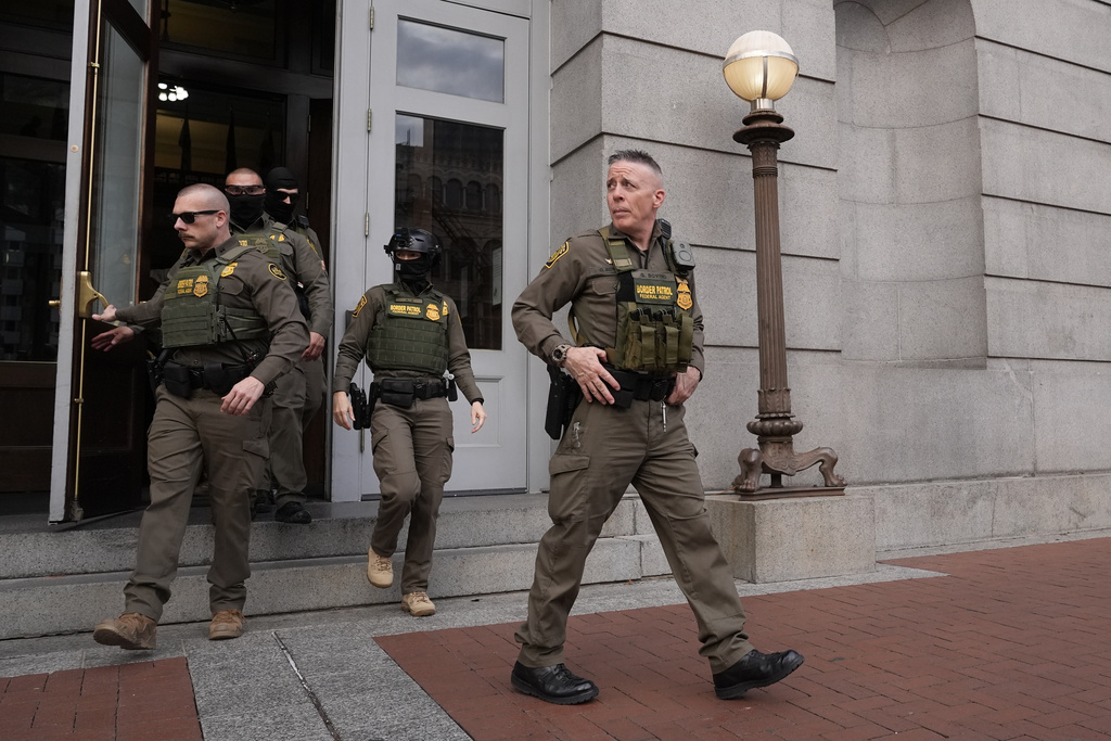 U.S. Border Patrol Commander at large Gregory Bovino, 1st right, walks on the street in New Orleans, La.,Wednesday, Dec. 3, 2025. (AP Photo/Gerald Herbert)