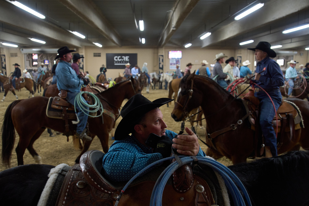 Contestants wait to compete during the World Series of Team Roping at the South Point hotel-casino in Las Vegas Tuesday, Dec. 9, 2025, in Las Vegas. (AP Photo/John Locher)
