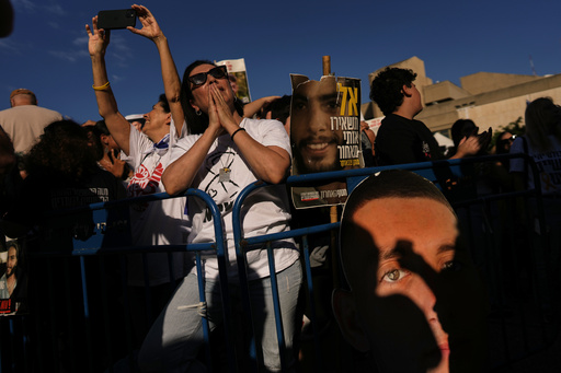 People gather to watch a live broadcast of Israeli hostages released from Gaza at a plaza known as hostages square in Tel Aviv, Israel, Monday, Oct. 13, 2025. The release took place as part of a cease-fire agreement between Israel and Hamas. (AP Photo/Oded Balilty) People gather to watch a live broadcast of Israeli hostages released from Gaza at a plaza known as hostages square in Tel Aviv, Israel, Monday, Oct. 13, 2025. The release took place as part of a cease-fire agreement between Israel and Hamas. (AP Photo/Oded Balilty)