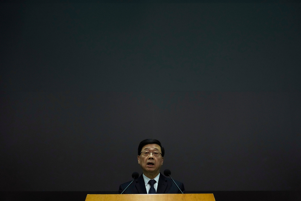 Hong Kong Chief Executive John Lee speaks during a press conference with a darken screen in the aftermath of a deadly fire in Hong Kong on Tuesday, Dec. 2, 2025. (AP Photo/Ng Han Guan)