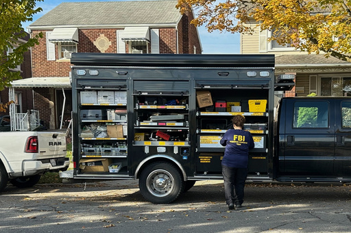 An FBI agent stands by an Evidence Response Team truck outside a home in a Dearborn, Mich., neighborhood on Friday, Oct. 31, 2025. (AP Photo/Mike Householder) An FBI agent stands by an Evidence Response Team truck outside a home in a Dearborn, Mich., neighborhood on Friday, Oct. 31, 2025. (AP Photo/Mike Householder)