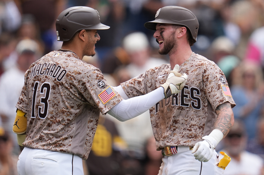 San Diego Padres' Jackson Merrill, right, celebrates his home run with teammate Manny Machado during the seventh inning of a baseball game against the Colorado Rockies Sunday, April 12, 2026, in San Diego. (AP Photo/Gregory Bull)