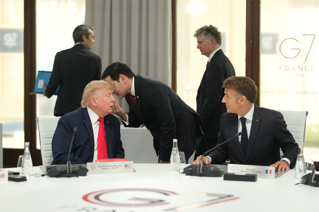 United States Secretary of State Marco Rubio, center, speaks with U.S. President Donald Trump, left, during a working session at the G7 summit in Evian-les-Bains, France, Tuesday, June 16, 2026. (AP Photo/Thibault Camus, Pool)