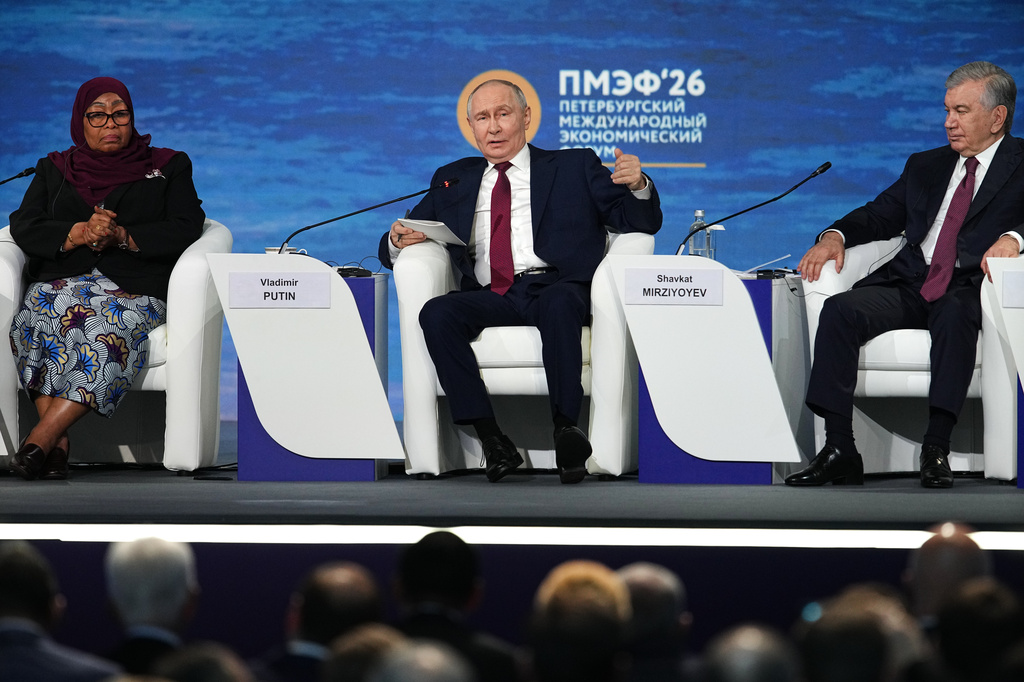 Russian President Vladimir Putin, center, speaks as Tanzanian President Samia Suluhu Hassan, left, and Uzbekistan's President Shavkat Mirziyoyev sit near during a plenary session at the St. Petersburg International Economic Forum in St. Petersburg, Russia, on Friday, June 5, 2026. (AP Photo/Dmitri Lovetsky)