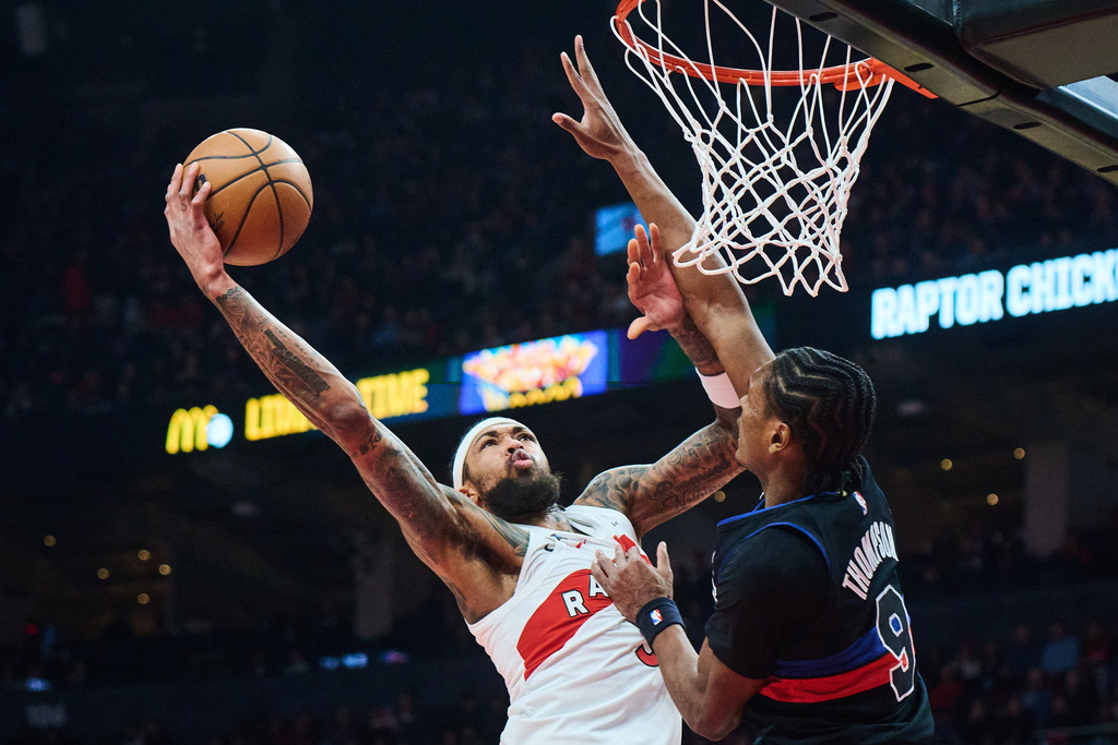 Toronto Raptors' Brandon Ingram (3) drives to the net past Detroit Pistons' Ausar Thompson (9) during the first half of an NBA basketball game in Toronto, Wednesday, Feb. 11, 2026. (Sammy Kogan/The Canadian Press via AP)