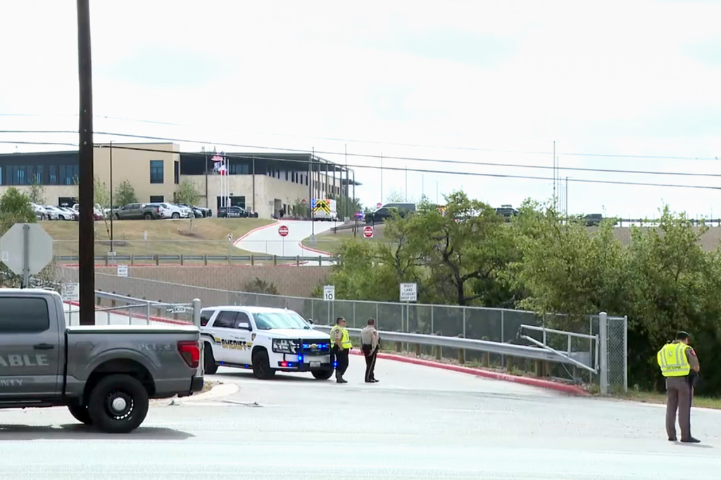 This image taken from video provided by KSAT shows first responders outside after a student shot a teacher at Hill Country College Preparatory High School, Monday, March 30, 2026, in Bulverde, Texas. (KSAT via AP)