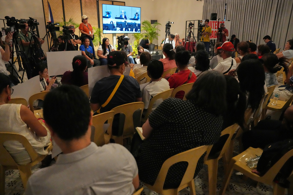 Families of victims on the deadly anti-drugs crackdowns of former Philippine President Rodrigo Duterte watch a live stream of Duterte's pre-trial hearing from The Hague, at a venue in Quezon City, Philippines on Monday, Feb. 23, 2026. (AP Photo/Aaron Favila)