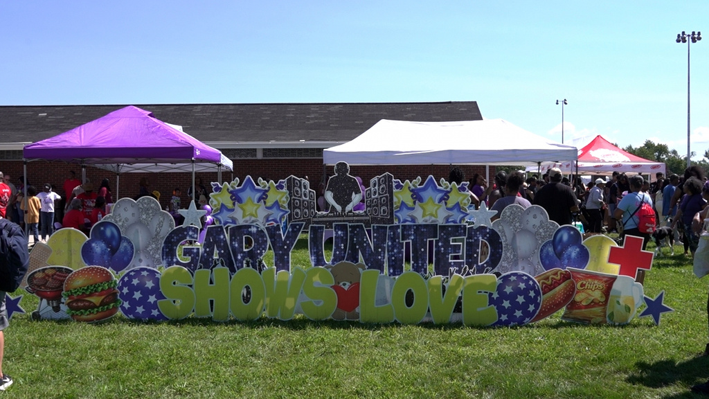 In this photo taken from video, a sign reads "Gary united shows love", at a free community relief event for those struggling after a nearly two-week long power outage in Gary, Ind., Aug. 24, 2026. (AP Photo/Laura Bargfeld)