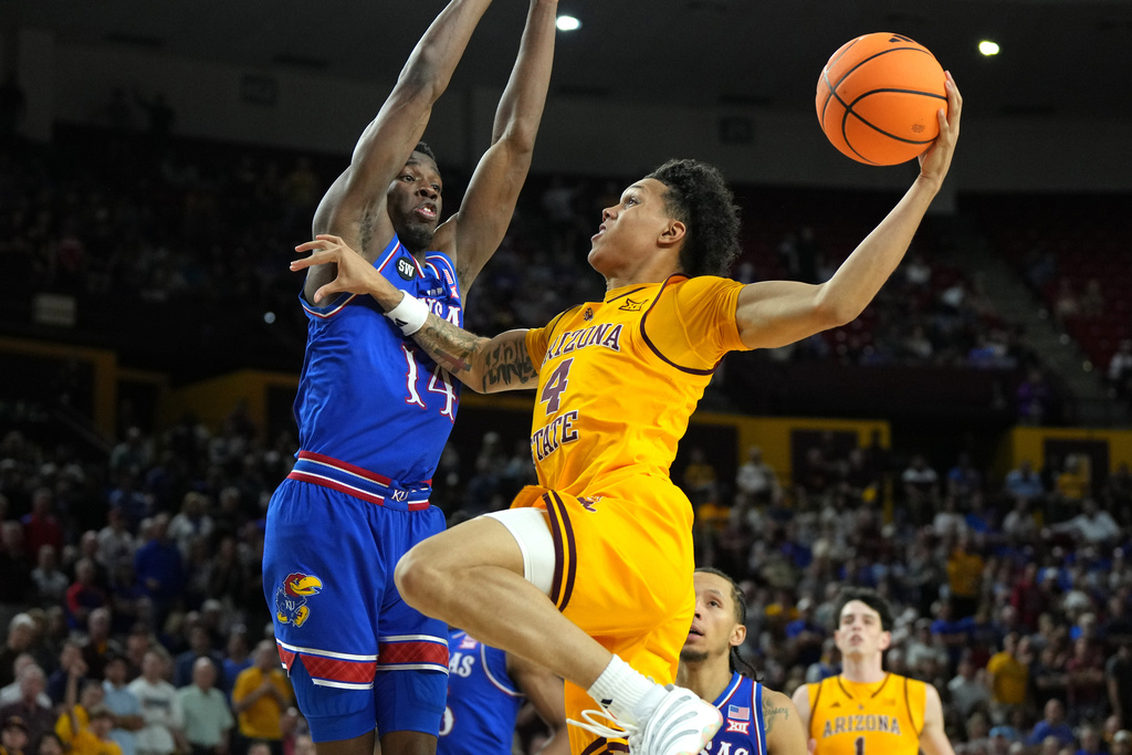 Arizona State guard Bryce Ford (4) drives on Kansas guard Melvin Council Jr. during the second half of an NCAA college basketball game, Tuesday, March 3, 2026, in Tempe, Ariz. (AP Photo/Rick Scuteri)