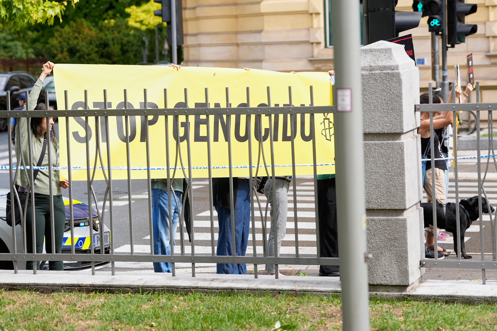 A group of protesters hold a banner outside the Slovenian foreign ministry during a visit of Israel's Foreign Minister Gideon Sa'ar, in Ljubljana, Slovenia, Wednesday, Sept. 9, 2026. (AP Photo/Darko Bandic)