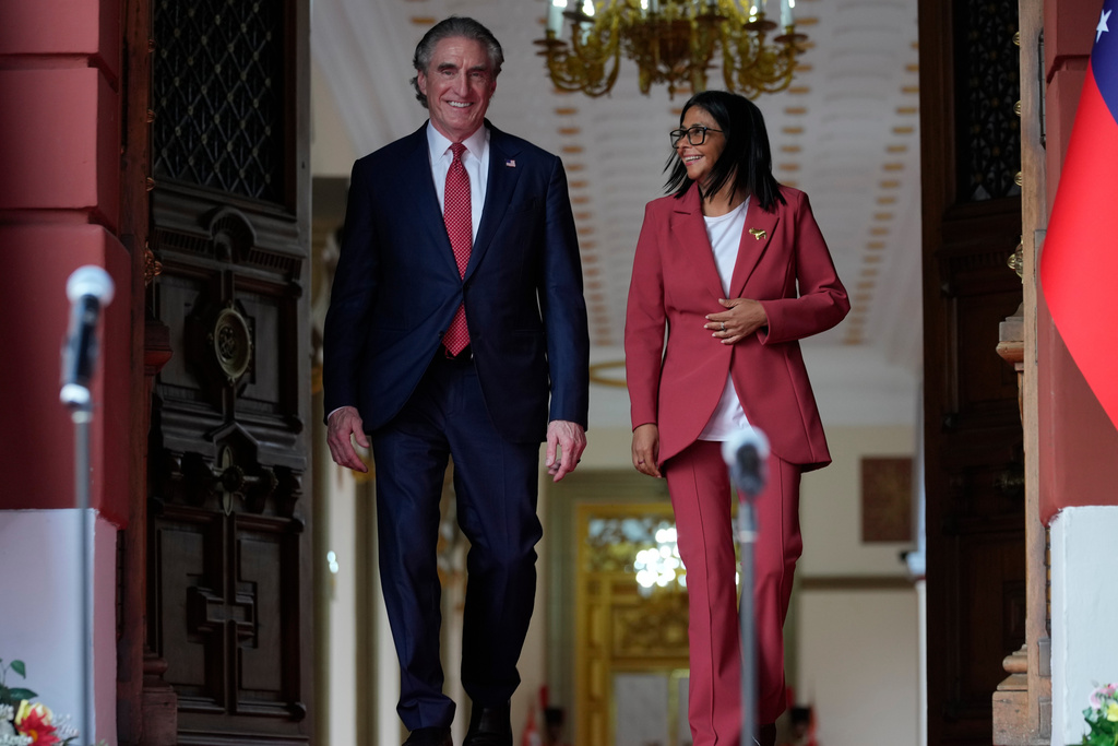 Venezuela's acting President Delcy Rodriguez, right, and U.S. Interior Secretary Doug Burgum walk after a meeting at Miraflores presidential palace in Caracas, Venezuela, Wednesday, March 4, 2026. (AP Photo/Ariana Cubillos)