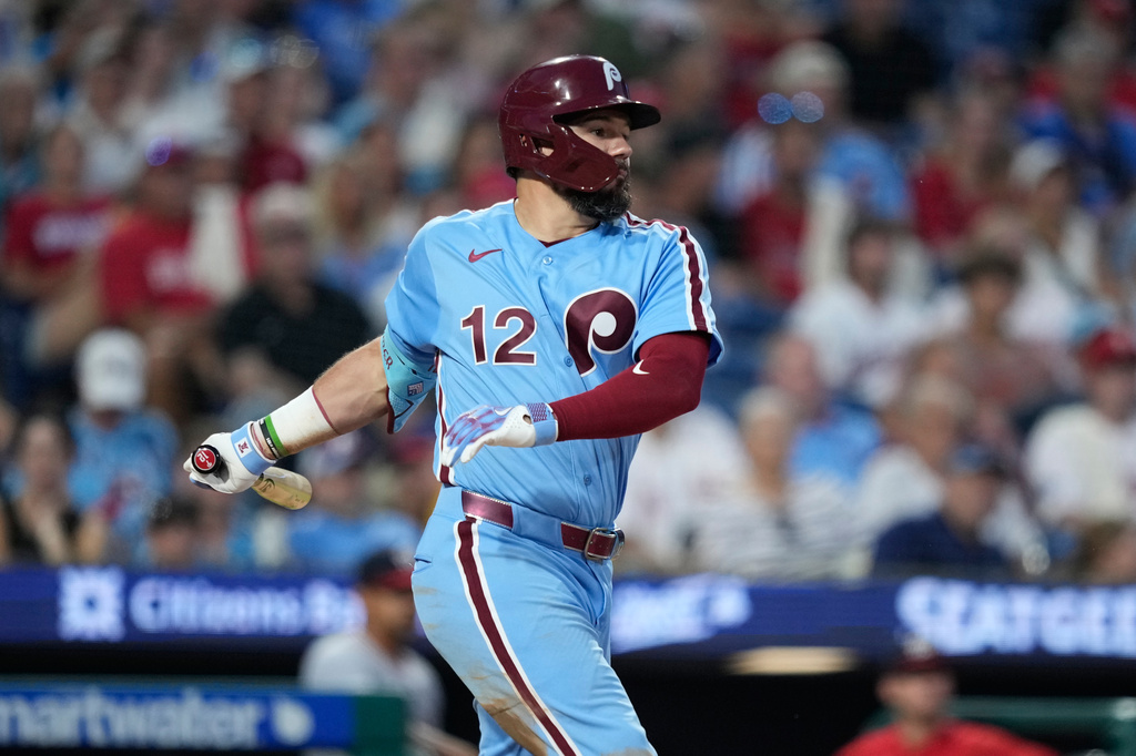 Philadelphia Phillies' Kyle Schwarber follows through after hitting a run-scoring single against Washington Nationals pitcher Max Kranick during the sixth inning of a baseball game Thursday, Aug. 6, 2026, in Philadelphia. (AP Photo/Matt Slocum)