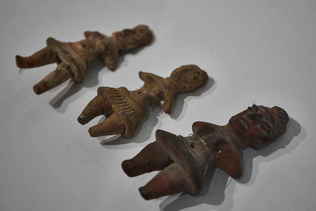 Clay figurines of women found in an excavation sit on display at a museum in the Cuicuilco Archaeological Zone in Mexico City, Sunday, Oct. 5, 2025. (AP Photo/Ginnette Riquelme)