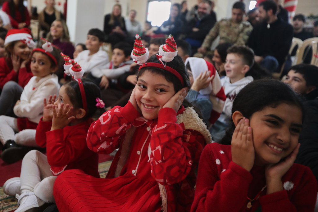 Children celebrate Christmas Eve in the southern Lebanese border village of Alma al-Shaab, near the Israeli border, Wednesday, Dec. 24, 2025. (AP Photo/Mohammed Zaatari)
