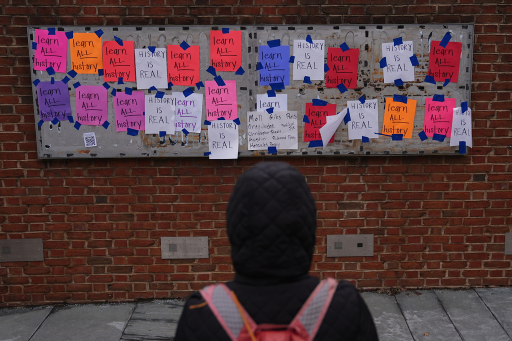 FILE - A person views posted signs on the locations of the now removed explanatory panels that were part of an exhibit on slavery at President's House Site in Philadelphia, Jan. 23, 2026. (AP Photo/Matt Rourke, File)