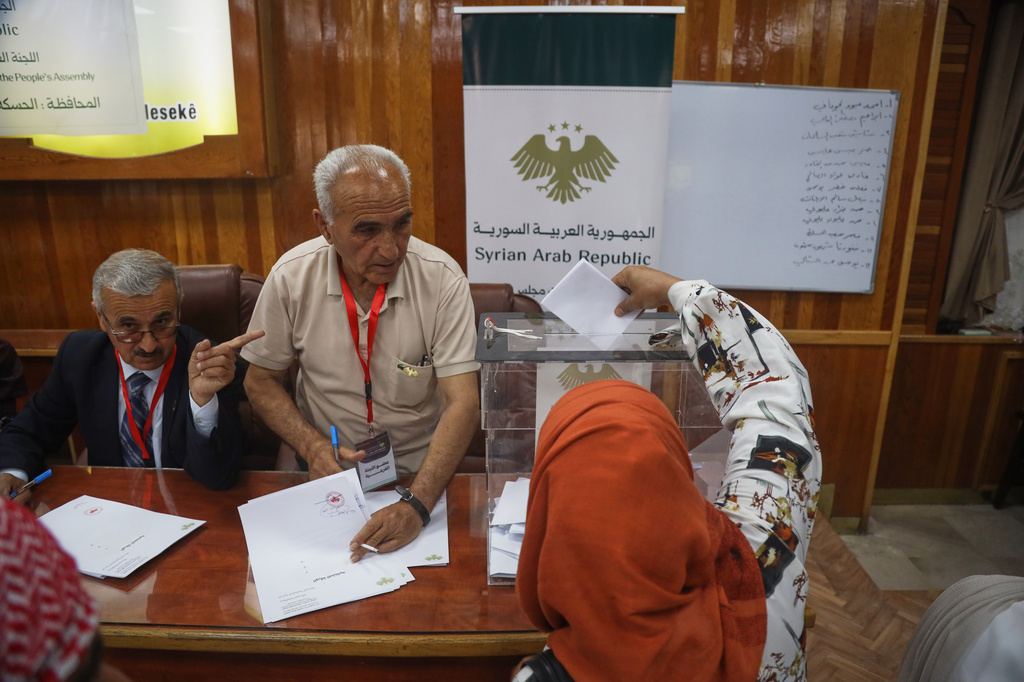 A voter casts a ballot during follow-up parliamentary elections in Hassakeh, northeastern Syria, Sunday, May 24, 2026. (AP Photo/Baderkhan Ahmad)