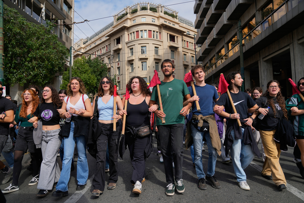 Protesters take part in a nationwide 24-hour strike in Athens, Greece, Tuesday, Oct. 14, 2025, as labor unions demand higher wages and the withdrawal of a bill changing work hours. (AP Photo/Petros Giannakouris)