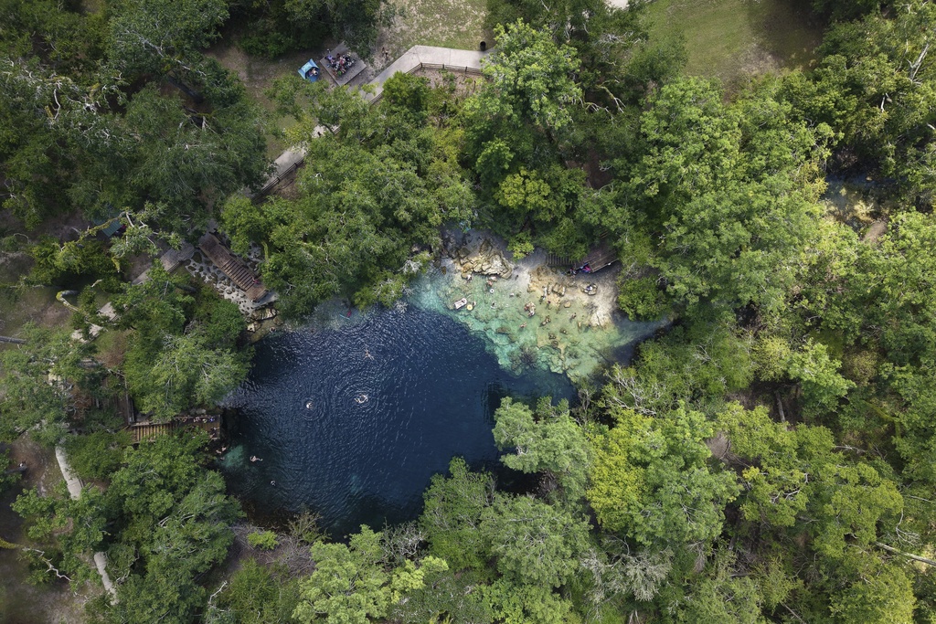 Visitors swim at Royal Spring, Tuesday, July 15, 2025, in Suwannee County, Fla. (AP Photo/Daniel Kozin)