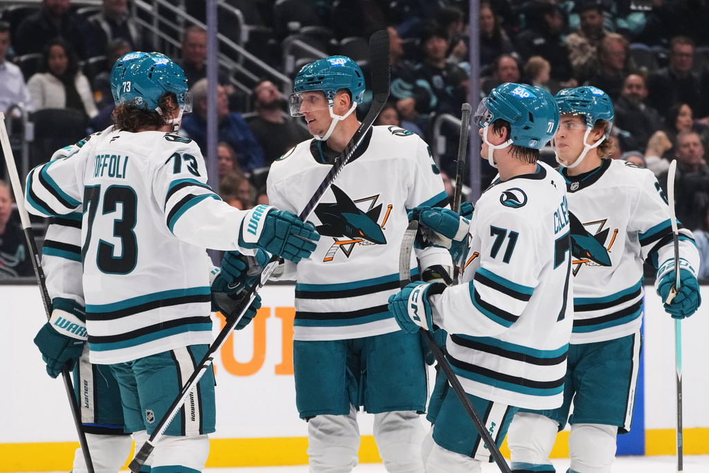 San Jose Sharks defenseman John Klingberg, center, celebrates his goal against the Seattle Kraken with teammates, including Tyler Toffoli (73) and Macklin Celebrini (71) during the second period of an NHL hockey game Wednesday, Nov. 5, 2025, in Seattle. (AP Photo/Lindsey Wasson)