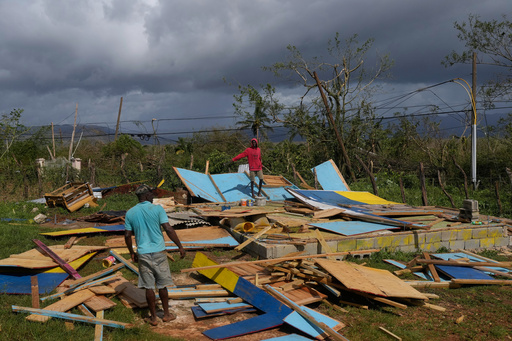 Residents stand on the wreckage of a house destroyed by Hurricane Melissa in Santa Cruz, Jamaica, Wednesday, Oct. 29, 2025. (AP Photo/Matias Delacroix) Residents stand on the wreckage of a house destroyed by Hurricane Melissa in Santa Cruz, Jamaica, Wednesday, Oct. 29, 2025. (AP Photo/Matias Delacroix)