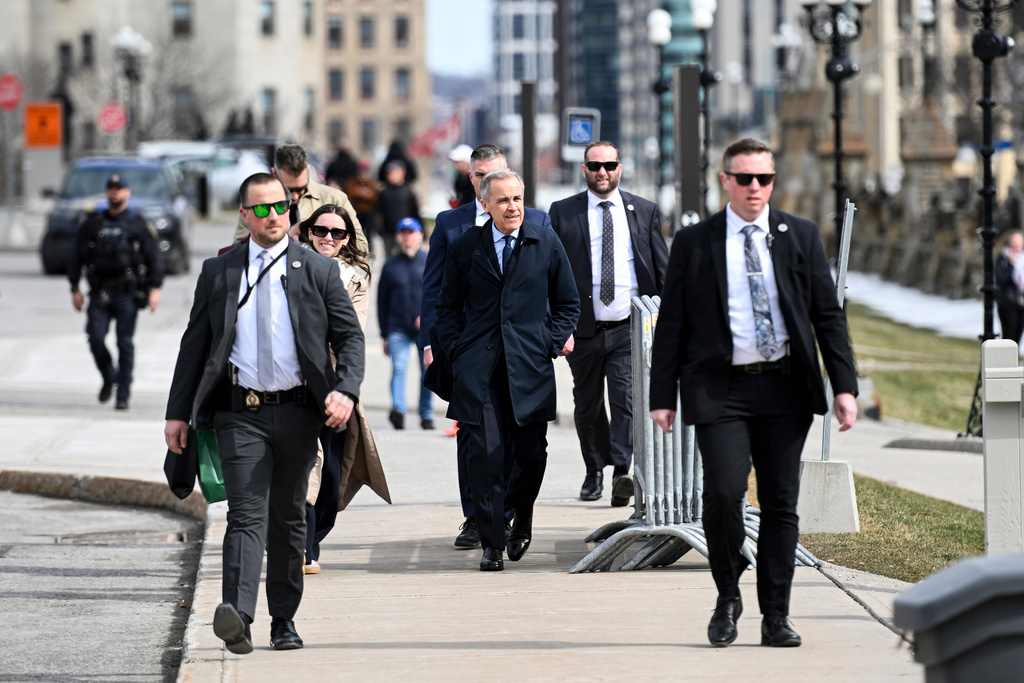 Canada's Prime Minister Mark Carney makes his way towards West Block on Parliament Hill in Ottawa, Ontario, Tuesday, March 10, 2026. (Spencer Colby/The Canadian Press via AP)