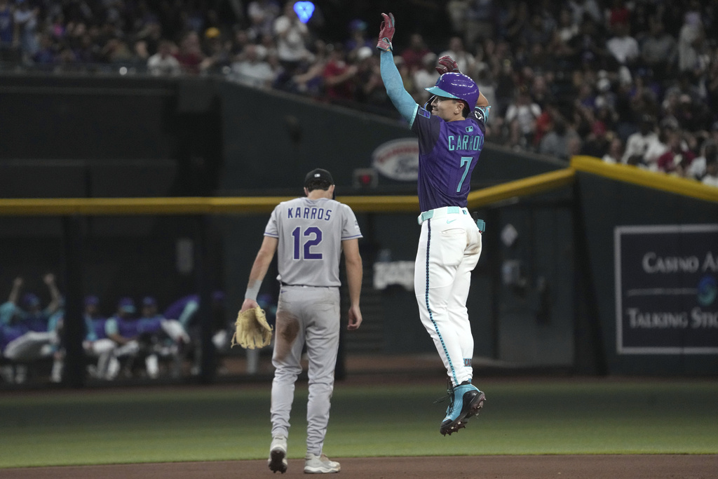 Arizona Diamondbacks' Corbin Carroll (7) reacts after hitting a two-run home run against the Colorado Rockies in the fifth inning of a baseball game, Friday, Aug. 8, 2025, in Phoenix. (AP Photo/Rick Scuteri)