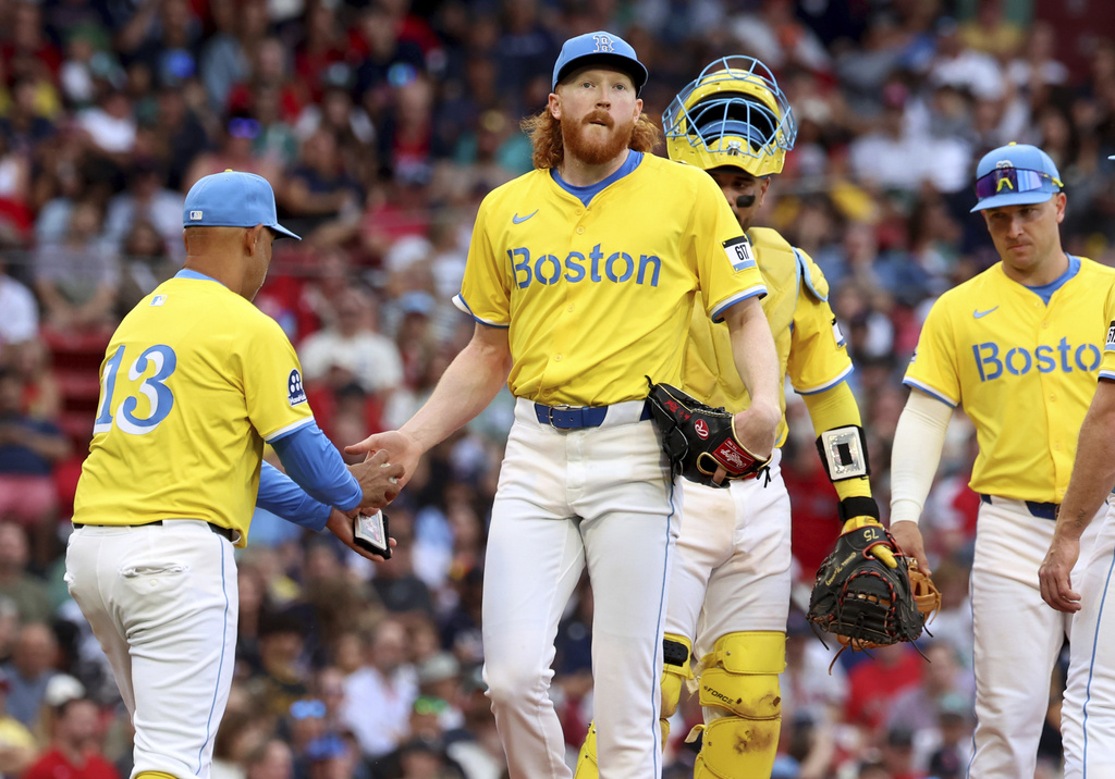 Boston Red Sox manager Alex Cora (13) takes the ball from pitcher Dustin May, center, as May leaves the mound during the sixth inning of a baseball game against the Pittsburgh Pirates, Saturday, Aug. 30, 2025, in Boston. (AP Photo/Mark Stockwell)