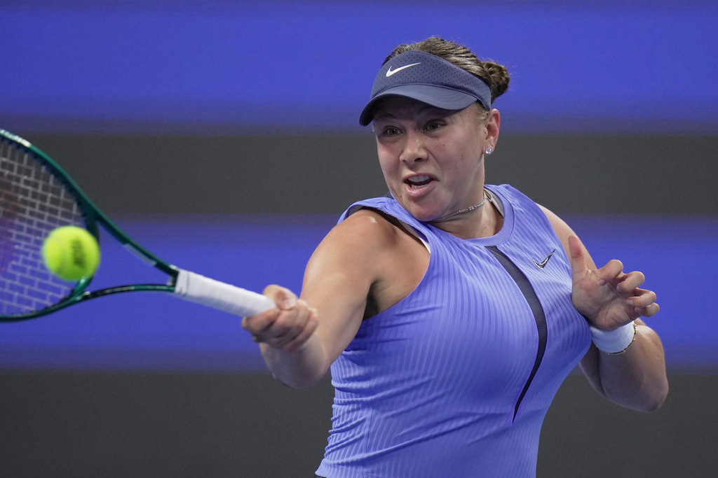 Amanda Anisimova of the United States plays a forehand return to Jasmine Paolini of Italy during the women's singles quarterfinals match of the China Open tennis tournament, at the National Tennis Center, in Beijing, Thursday, Oct. 2, 2025. (AP Photo/Andy Wong)