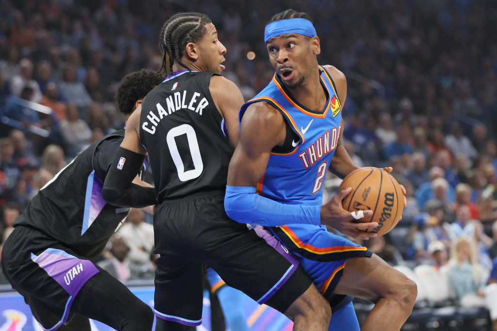 Oklahoma City Thunder guard Shai Gilgeous-Alexander (2) looks to go to the basket against Utah Jazz guard Kennedy Chandler (0) during the first half of an NBA basketball game Sunday, April 5, 2026, in Oklahoma City. (AP Photo/Nate Billings)