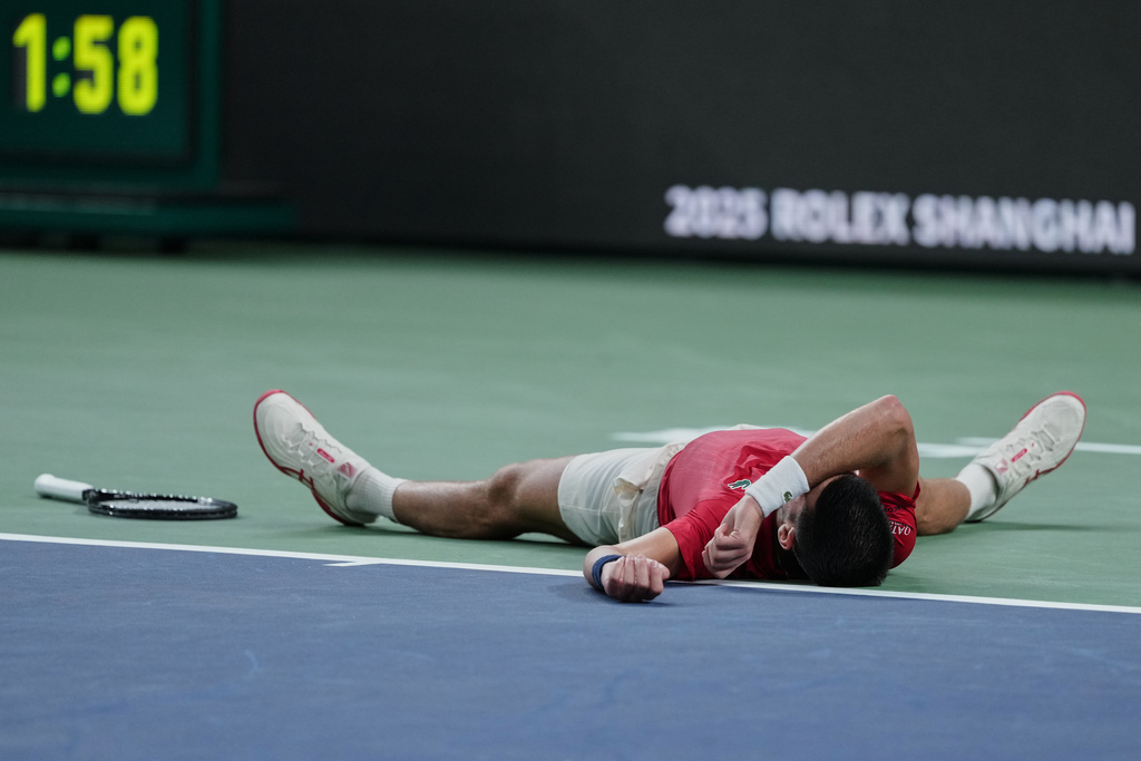 Novak Djokovic of Serbia reacts after losing the second set point to Jaume Munar of Spain during the men's singles match of the Shanghai Masters tennis tournament at Qizhong Forest Sports City Tennis Center, in Shanghai, China, Tuesday, Oct. 7, 2025. (AP Photo/Andy Wong)