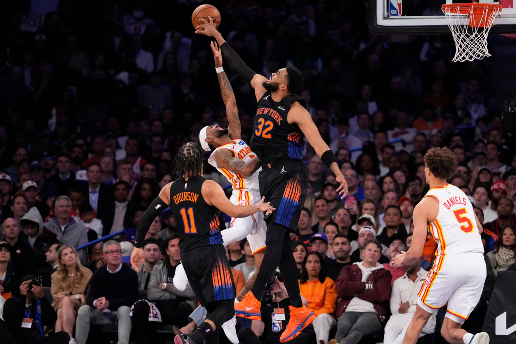 New York Knicks center Karl-Anthony Towns (32) blocks Atlanta Hawks guard Nickeil Alexander-Walker (7) during the first half in Game 2 of a first-round NBA playoffs basketball series, Monday, April 20, 2026, in New York. (AP Photo/Yuki Iwamura)
