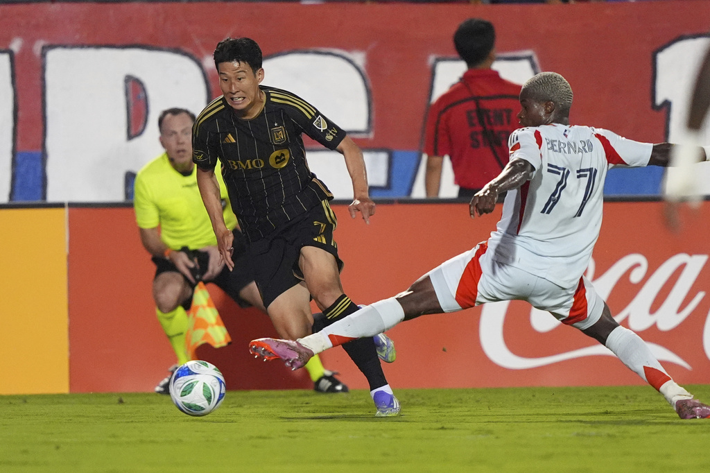 Los Angeles FC forward Heung Min Son, front left, gets past FC Dallas forward Bernard Kamungo (77) during the first half of an MLS soccer match in Frisco, Texas, Saturday, Aug. 23, 2025. (AP Photo/LM Otero)