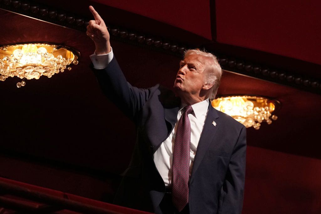 President Donald Trump gestures before the premiere of first lady Melania Trump's movie "Melania" at The John F. Kennedy Memorial Center For The Performing Arts, Thursday, Jan. 29, 2026, in Washington. (AP Photo/Allison Robbert)