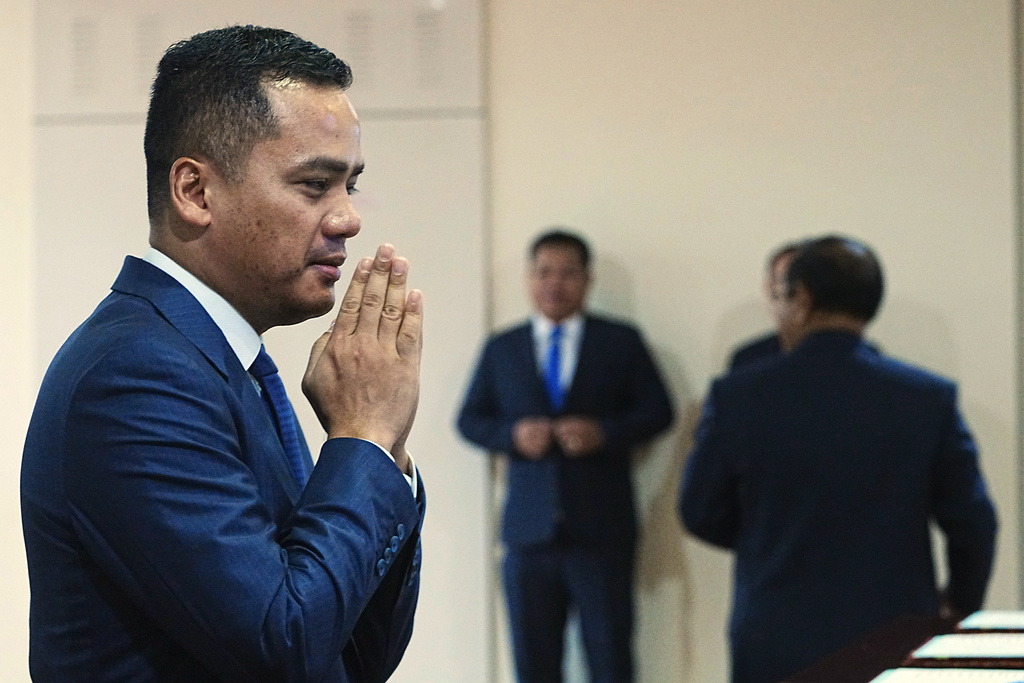 Cambodian Deputy Prime Minister and Minister of Interior Sar Sokha, left, greets before the session on the draft law on amending the law on nationality at the National Assembly in Phnom Penh Cambodia, Monday, Aug. 25, 2025. (AP Photo/Heng Sinith)