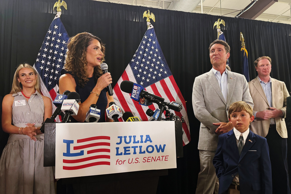 U.S. Rep. Julia Letlow, standing beside her fiancee Kevin Ainsworth, center right, and her son, addresses her supporters in Baton Rouge, La., Saturday, June 27, 2026, after winning the GOP Senate nomination. (AP Photo/Jack Brook)