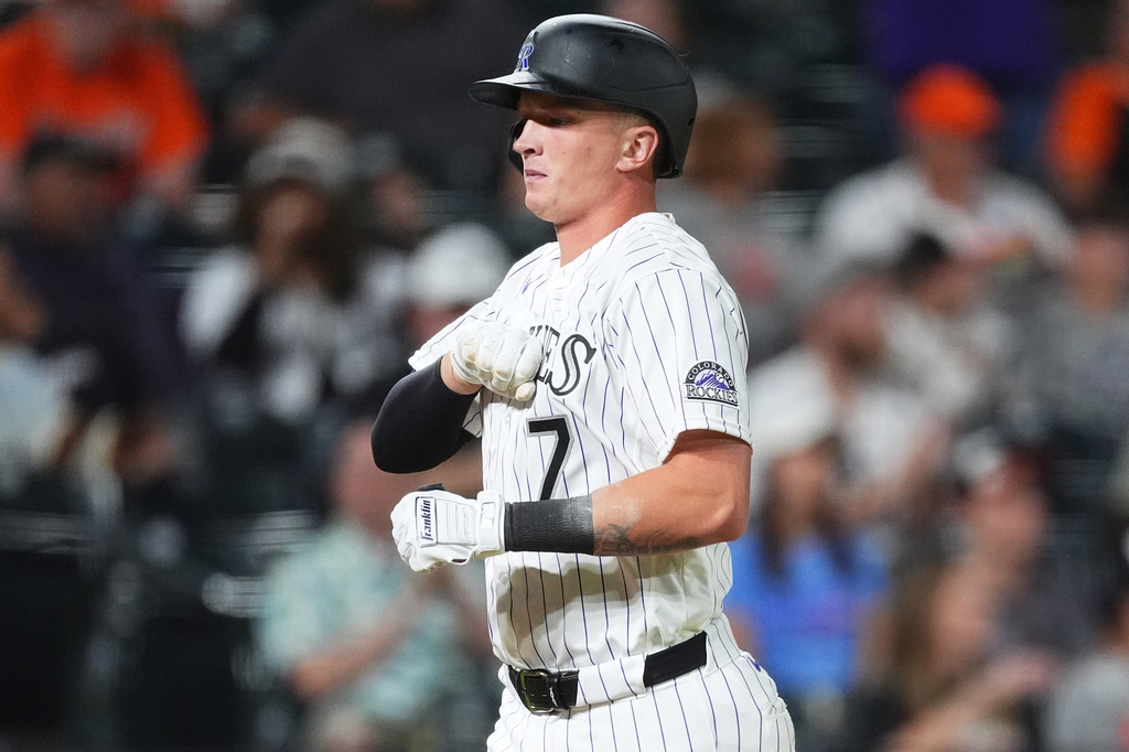 Colorado Rockies' TJ Rumfield gestures as he crosses home plate after hitting a two-run home run off Baltimore Orioles relief pitcher Luis De Leon in the seventh inning of a baseball game Tuesday, Sept. 1, 2026, in Denver. (AP Photo/David Zalubowski)