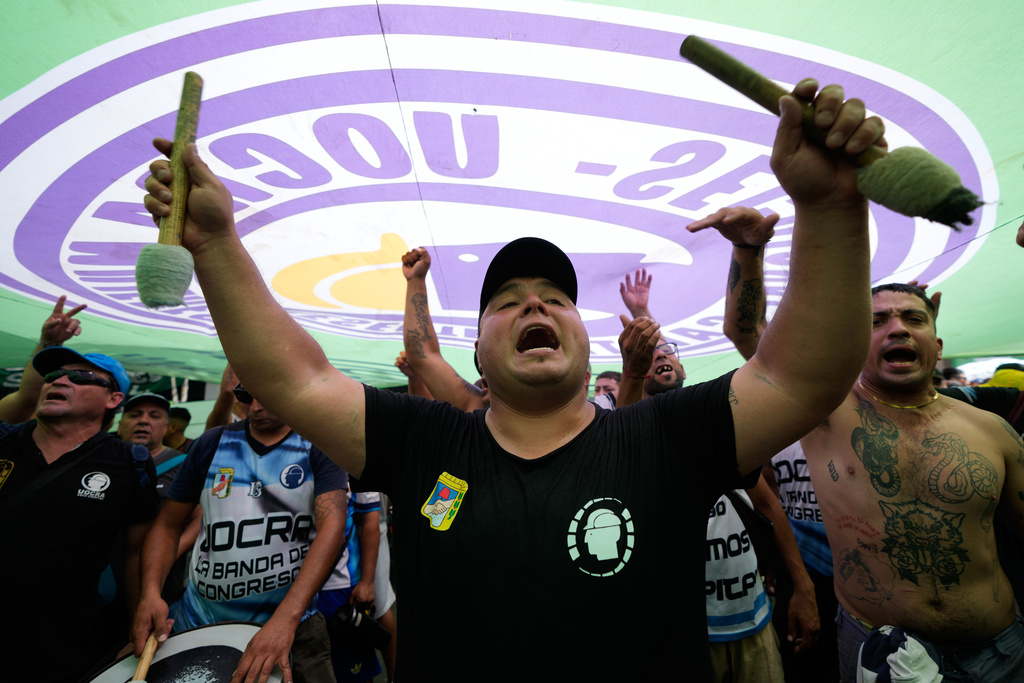 Protesters chant during a march by trade unions and opposition groups against a labor reform bill proposed by President Javier Milei's government in Buenos Aires, Argentina, Wednesday, Feb. 11, 2026.(AP Photo/Gustavo Garello)
