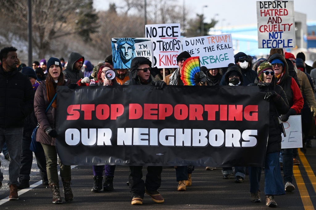 Protesters gather at a rally for immigrant and worker outside Signature Aviation near the Minneapolis–Saint Paul International Airport, Wednesday, Dec 3, 2025, in Minneapolis. (AP Photo/Tom Baker)