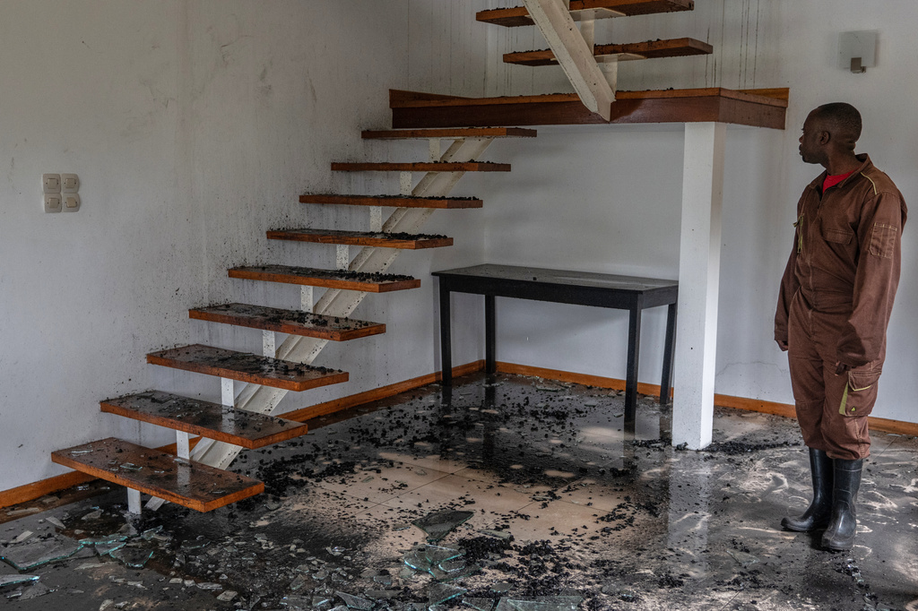 A man stands in a house hit by a drone strike in Goma, Democratic Republic of Congo, Wednesday, March 11, 2026. (AP Photo/Moses Sawasawa)